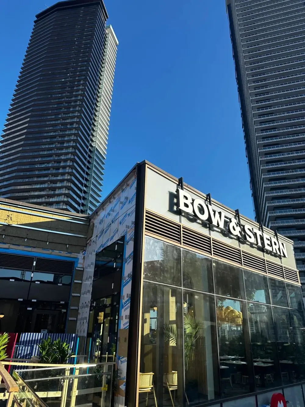 Exterior of Bow & Stern restaurant in Brentwood, Burnaby, with its sign beneath two towers